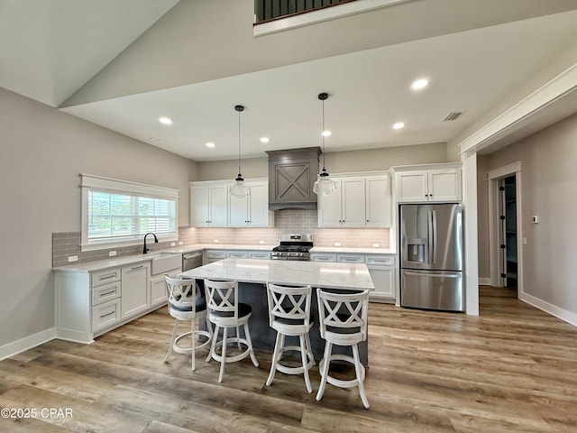 3391 Grey Oak Way, Marianna, FL 32446 - kitchen with appliances with stainless steel finishes, a kitchen island, white cabinetry, tasteful backsplash, and recessed lighting
