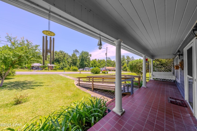 1016 Morgan Ave, Chattahoochee, FL 32324 - covered porch with a yard and view of wooded area