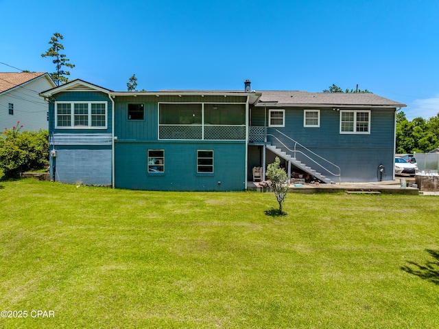 1016 Morgan Ave, Chattahoochee, FL 32324 - rear view of property with stairway, a lawn, and a sunroom