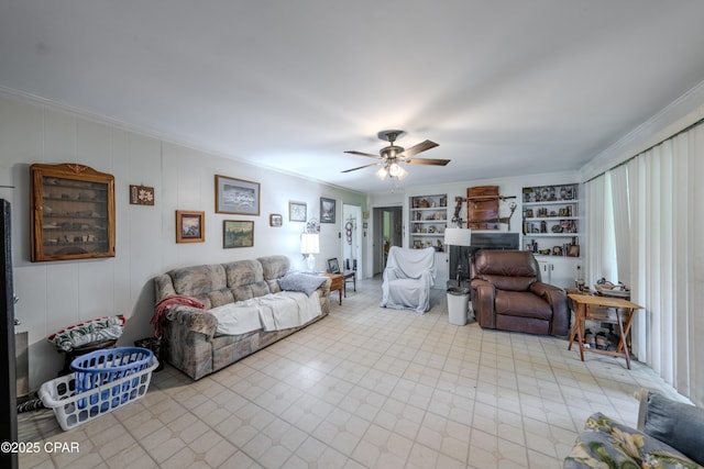 1016 Morgan Ave, Chattahoochee, FL 32324 - living area with crown molding, a fireplace, a ceiling fan, and built in shelves