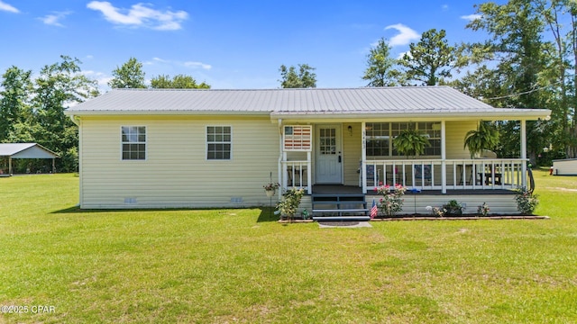 3483 Kynesville Rd, Marianna, FL 32448 - view of front facade featuring a front yard, covered porch, and a metal roof