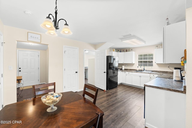 3483 Kynesville Rd, Marianna, FL 32448 - dining room with dark wood-style flooring and a chandelier
