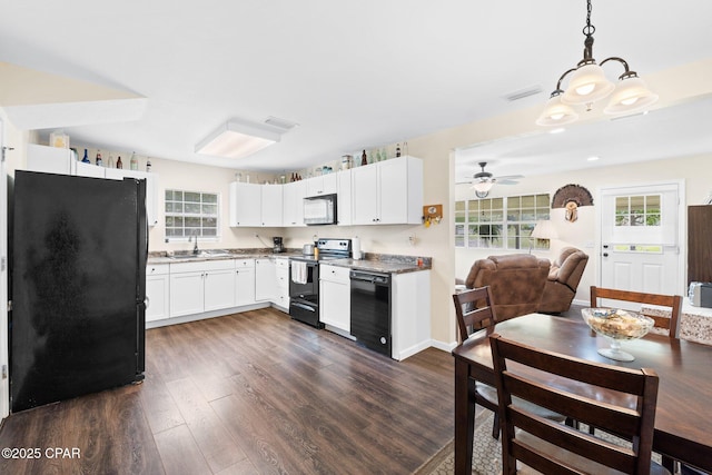 3483 Kynesville Rd, Marianna, FL 32448 - kitchen featuring range with electric stovetop, freestanding refrigerator, dark wood finished floors, open floor plan, and ceiling fan