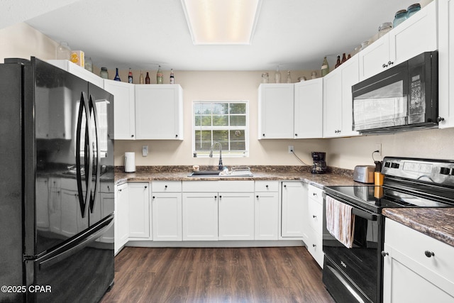 3483 Kynesville Rd, Marianna, FL 32448 - kitchen featuring black appliances, dark wood-type flooring, and white cabinetry