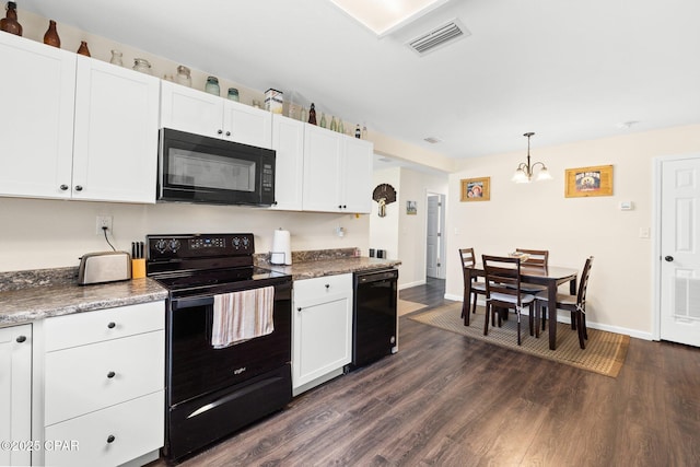 3483 Kynesville Rd, Marianna, FL 32448 - kitchen featuring black appliances, dark wood-type flooring, a chandelier, white cabinetry, and hanging light fixtures