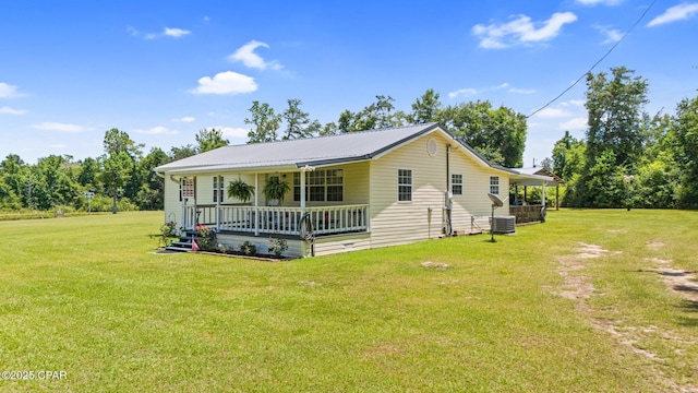 3483 Kynesville Rd, Marianna, FL 32448 - view of front facade featuring a porch, a front lawn, and a metal roof
