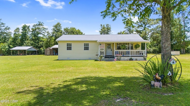 3483 Kynesville Rd, Marianna, FL 32448 - back of house featuring covered porch, a yard, a carport, a metal roof, and a shed