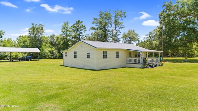 3483 Kynesville Rd, Marianna, FL 32448 - view of side of home featuring a lawn, a carport, view of scattered trees, and a metal roof
