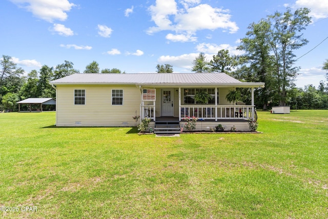 3483 Kynesville Rd, Marianna, FL 32448 - view of front of home featuring covered porch, a front yard, a metal roof, and a carport