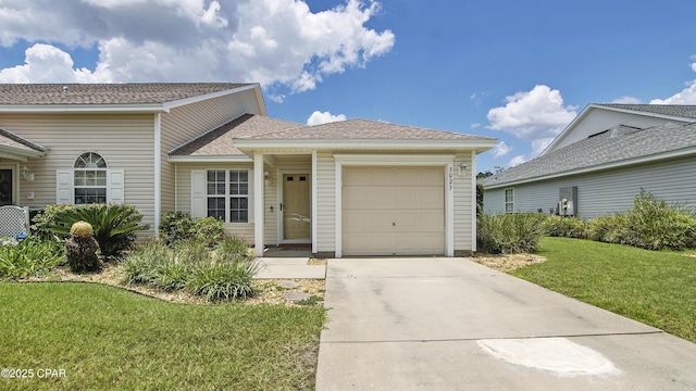 3023 Meadow St, Lynn Haven, FL 32444 - view of front facade featuring a garage, a front lawn, driveway, and a shingled roof