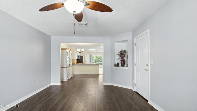 3023 Meadow St, Lynn Haven, FL 32444 - unfurnished living room with a chandelier, dark wood-type flooring, ceiling fan, and a textured ceiling