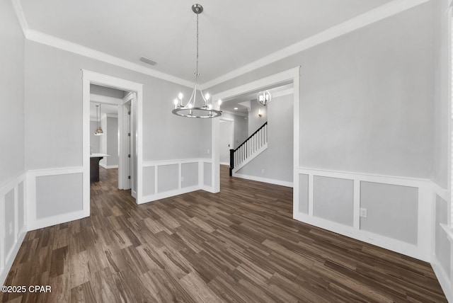 3033 Osprey Cir, Panama City, FL 32405 - unfurnished dining area featuring a chandelier, dark wood-style floors, wainscoting, ornamental molding, and a decorative wall
