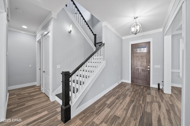 3033 Osprey Cir, Panama City, FL 32405 - foyer featuring dark wood-style flooring, stairs, crown molding, a chandelier, and recessed lighting