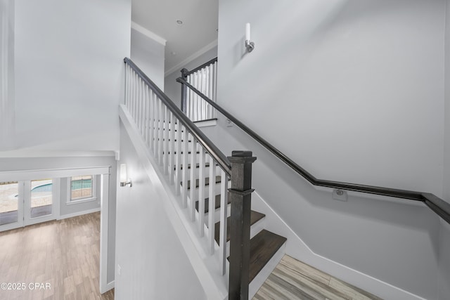 3033 Osprey Cir, Panama City, FL 32405 - stairs with a high ceiling, wood finished floors, and crown molding