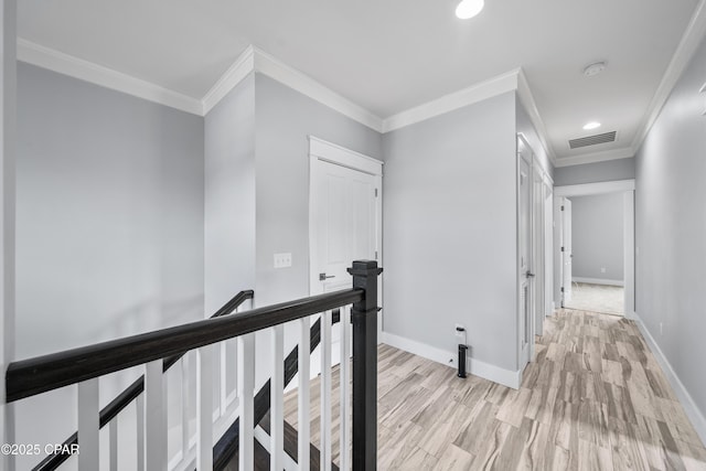 3033 Osprey Cir, Panama City, FL 32405 - hallway with an upstairs landing, light wood finished floors, ornamental molding, and recessed lighting