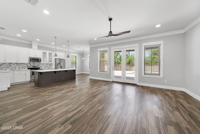 3033 Osprey Cir, Panama City, FL 32405 - unfurnished living room featuring a ceiling fan, ornamental molding, recessed lighting, dark wood-style flooring, and french doors