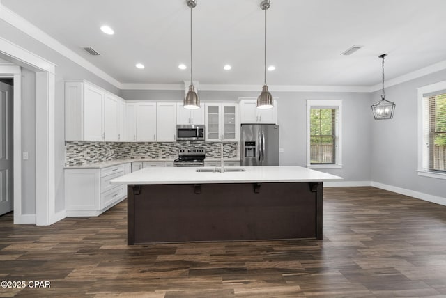 3033 Osprey Cir, Panama City, FL 32405 - kitchen with stainless steel appliances, plenty of natural light, light countertops, ornamental molding, and recessed lighting