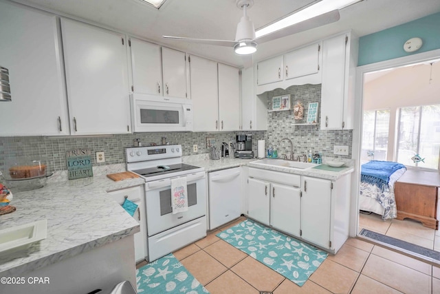 101 Gulf Loop, Panama City Beach, FL 32408 - kitchen with white appliances, light countertops, white cabinets, and backsplash