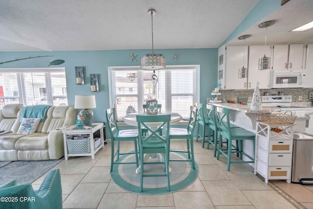 101 Gulf Loop, Panama City Beach, FL 32408 - dining room with a textured ceiling, plenty of natural light, and light tile patterned floors