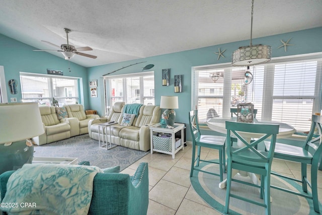 101 Gulf Loop, Panama City Beach, FL 32408 - living room featuring ceiling fan, lofted ceiling, light tile patterned flooring, and a textured ceiling