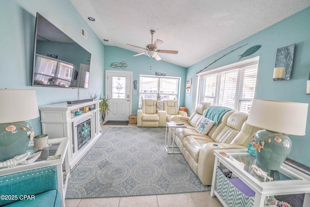 101 Gulf Loop, Panama City Beach, FL 32408 - tiled living area featuring lofted ceiling, ceiling fan, and a textured ceiling