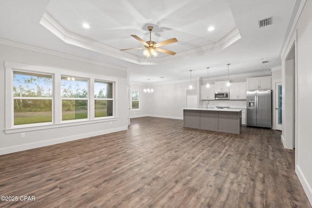 902 Captain Way, Panama City, FL 32404 - unfurnished living room featuring a raised ceiling, ornamental molding, ceiling fan, dark wood-type flooring, and recessed lighting
