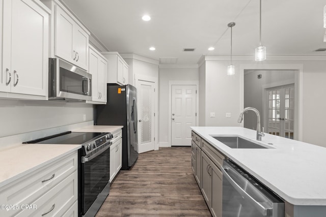 902 Captain Way, Panama City, FL 32404 - kitchen featuring stainless steel appliances, ornamental molding, a kitchen island with sink, dark wood finished floors, and light countertops