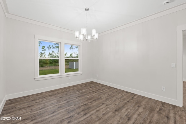 902 Captain Way, Panama City, FL 32404 - unfurnished room with a chandelier, dark wood finished floors, ornamental molding, and a smoke detector