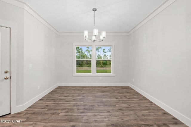 902 Captain Way, Panama City, FL 32404 - spare room featuring a chandelier, crown molding, and dark wood-type flooring