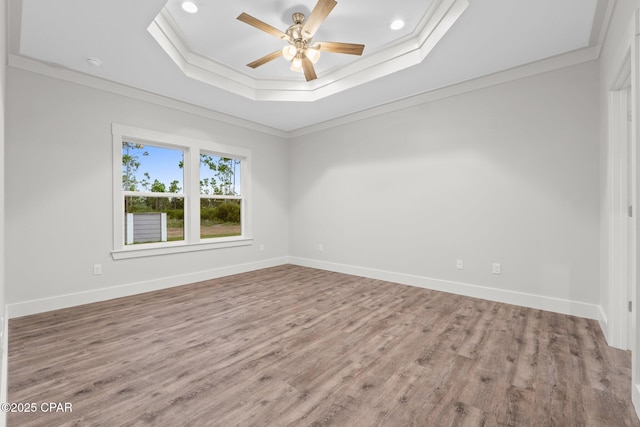902 Captain Way, Panama City, FL 32404 - spare room featuring a raised ceiling, a ceiling fan, wood finished floors, ornamental molding, and recessed lighting
