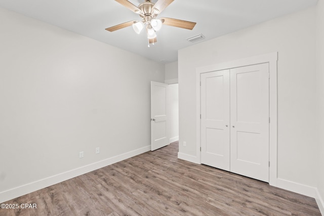 902 Captain Way, Panama City, FL 32404 - unfurnished bedroom featuring wood finished floors, a closet, and ceiling fan