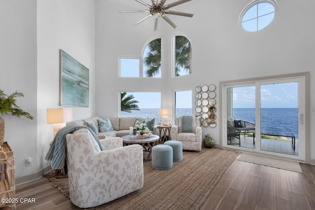 961 Northshore Dr Unit Sandestin, Miramar Beach, FL 32550 - living room with a towering ceiling, wood finished floors, plenty of natural light, a ceiling fan, and a water view