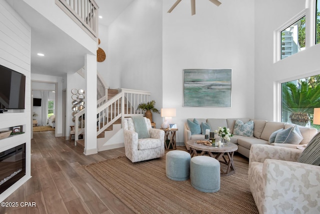 961 Northshore Dr Unit Sandestin, Miramar Beach, FL 32550 - living area featuring a towering ceiling, plenty of natural light, stairway, wood finished floors, and ceiling fan