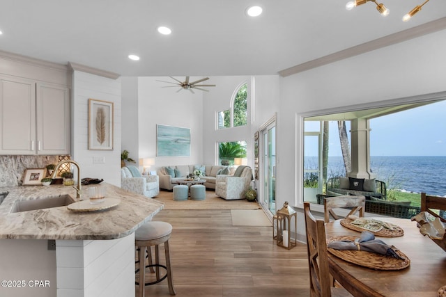 961 Northshore Dr Unit Sandestin, Miramar Beach, FL 32550 - kitchen featuring a kitchen bar, light stone countertops, a wood stove, recessed lighting, and light wood-type flooring