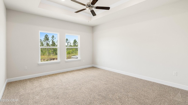 4866 Windrow Way, Panama City, FL 32404 - spare room featuring a tray ceiling, light carpet, crown molding, and a ceiling fan