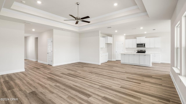 4866 Windrow Way, Panama City, FL 32404 - unfurnished living room with a raised ceiling, a ceiling fan, light wood-style floors, recessed lighting, and crown molding
