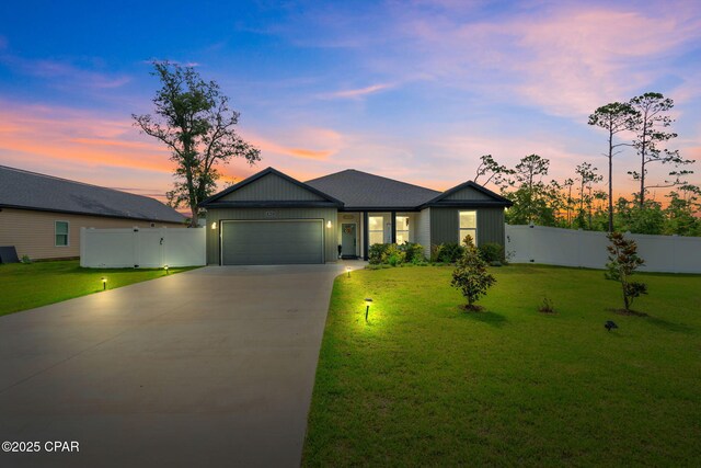 8422 Resota Beach Rd, Southport, FL 32409 - view of front facade with concrete driveway and a garage