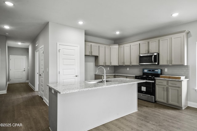237 Mosaic Dr Unit 42, Port St Joe, FL 32456 - kitchen with stainless steel appliances, gray cabinets, backsplash, dark wood-style flooring, and recessed lighting