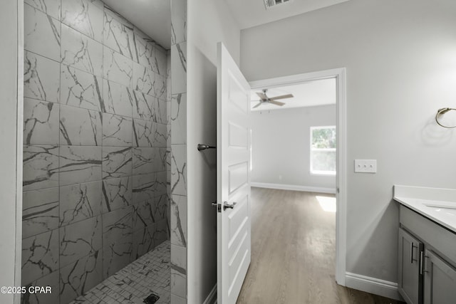 237 Mosaic Dr Unit 42, Port St Joe, FL 32456 - full bath featuring vanity, a tile shower, wood finished floors, and a ceiling fan