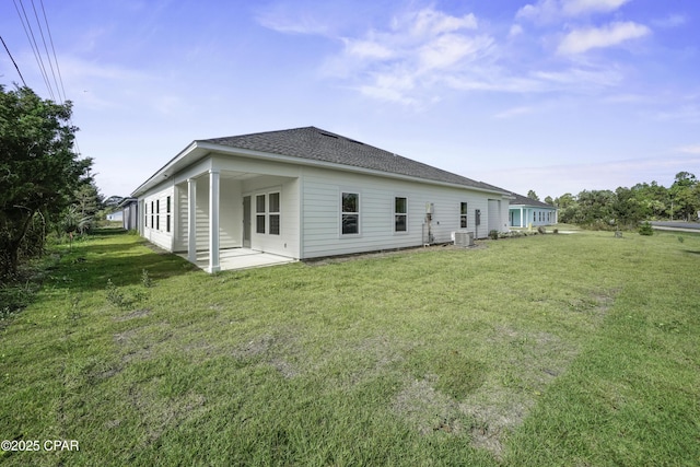 237 Mosaic Dr Unit 42, Port St Joe, FL 32456 - back of house featuring a patio area, a yard, and roof with shingles