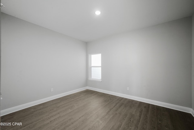 237 Mosaic Dr Unit 42, Port St Joe, FL 32456 - empty room featuring dark wood-type flooring and baseboards