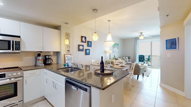 11807 Front Beach Rd Unit 1-1608, Panama City Beach, FL 32407 - kitchen with appliances with stainless steel finishes, a peninsula, ceiling fan, open floor plan, and white cabinetry