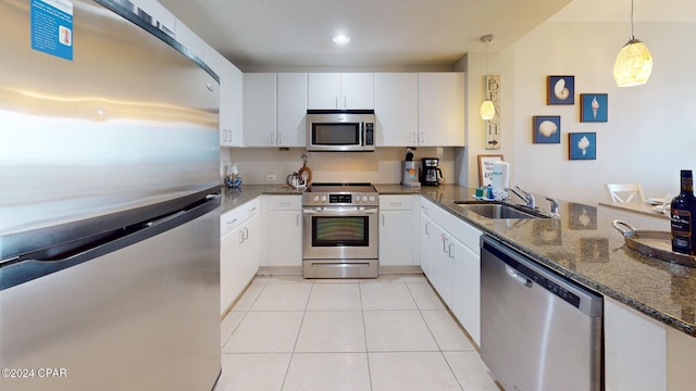 11807 Front Beach Rd Unit 1-1608, Panama City Beach, FL 32407 - kitchen featuring appliances with stainless steel finishes, hanging light fixtures, dark stone countertops, and white cabinets