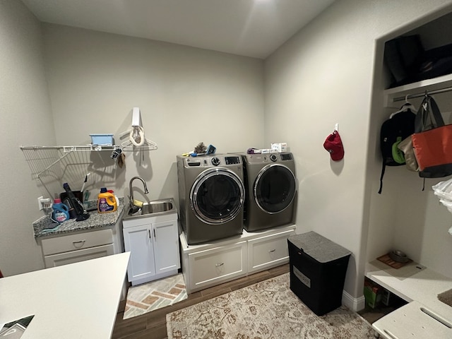 1733 Overhill Dr, San Angelo, TX 76904 - laundry room with separate washer and dryer, cabinet space, and wood finished floors