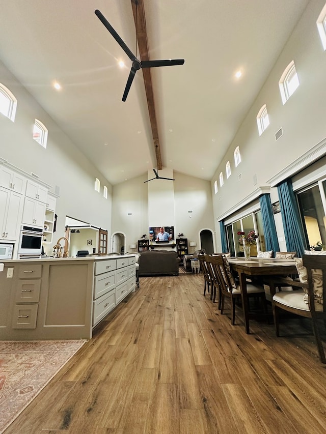 1733 Overhill Dr, San Angelo, TX 76904 - dining room with high vaulted ceiling, light wood-type flooring, beam ceiling, and ceiling fan