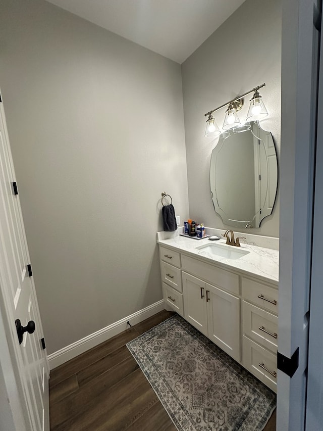 1733 Overhill Dr, San Angelo, TX 76904 - bathroom with vanity, wood finished floors, and baseboards