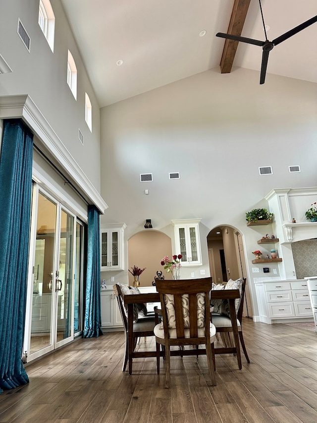 1733 Overhill Dr, San Angelo, TX 76904 - dining area with high vaulted ceiling, arched walkways, hardwood / wood-style flooring, beamed ceiling, and a ceiling fan