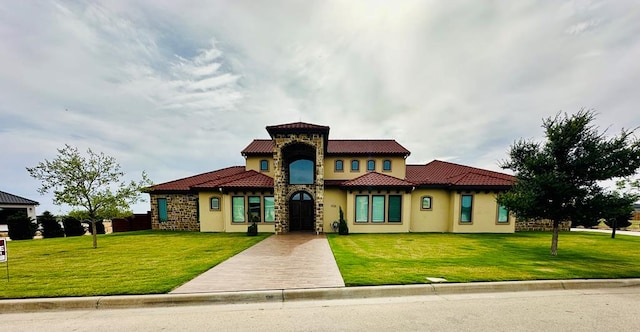 1733 Overhill Dr, San Angelo, TX 76904 - mediterranean / spanish house with stucco siding, a front lawn, and a tile roof
