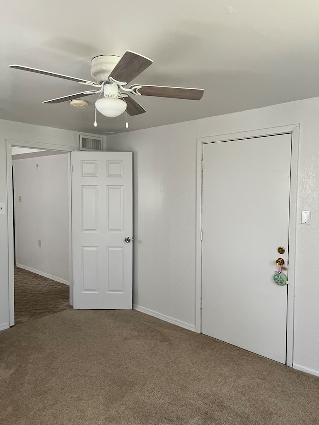 unfurnished bedroom featuring ceiling fan and carpet floors