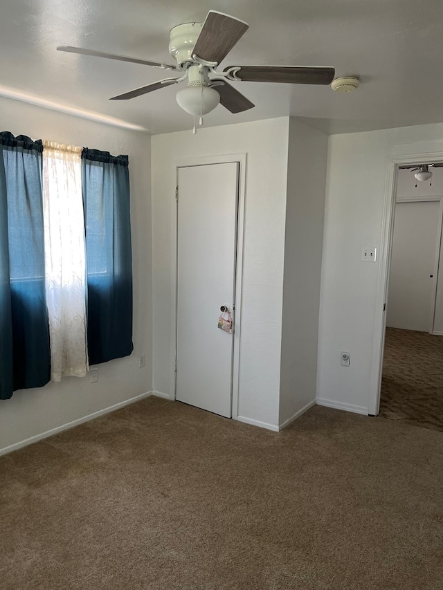 unfurnished bedroom featuring ceiling fan and carpet